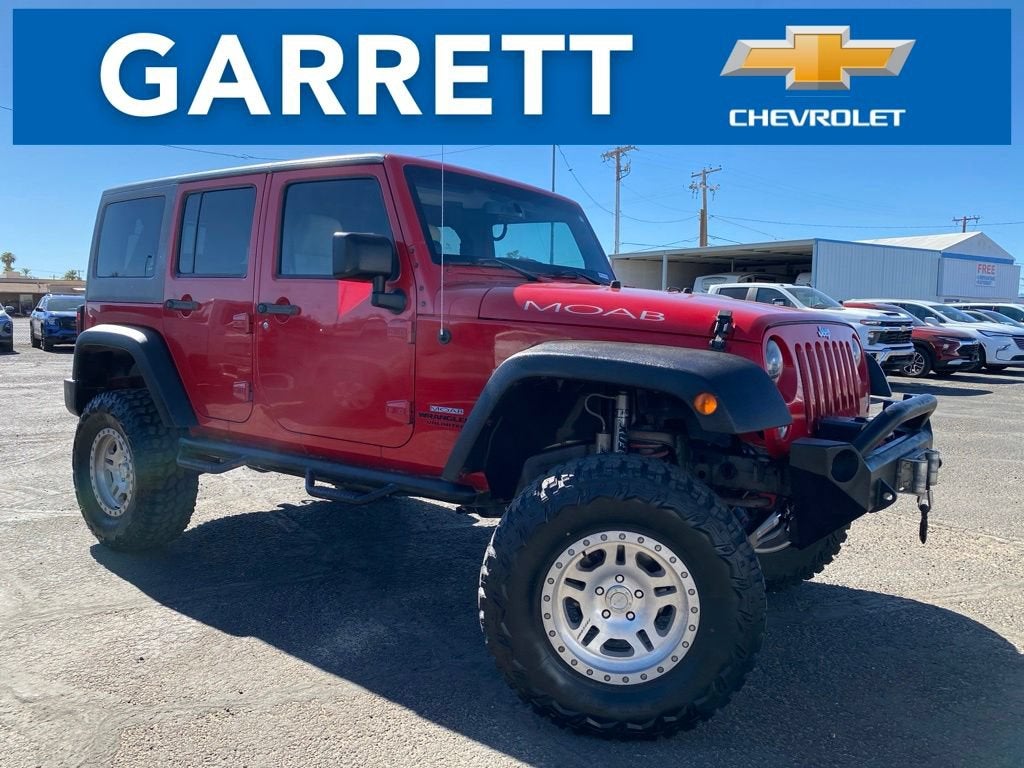 2014 Jeep Wrangler Unlimited Sport in Red — front three-quarter view